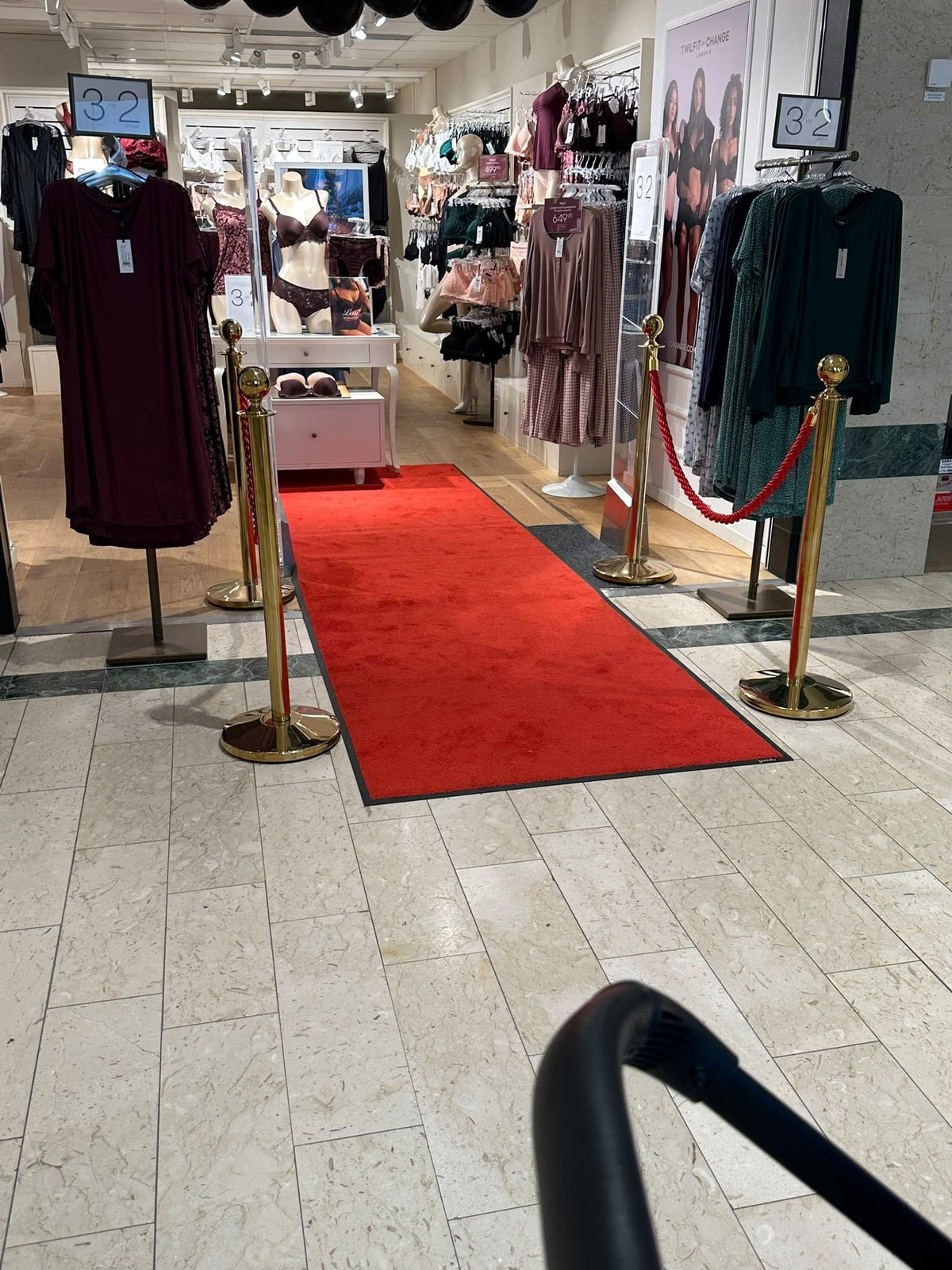 How a Retail Store Created a VIP Entrance with a Red Carpet and Gold Barrier Posts